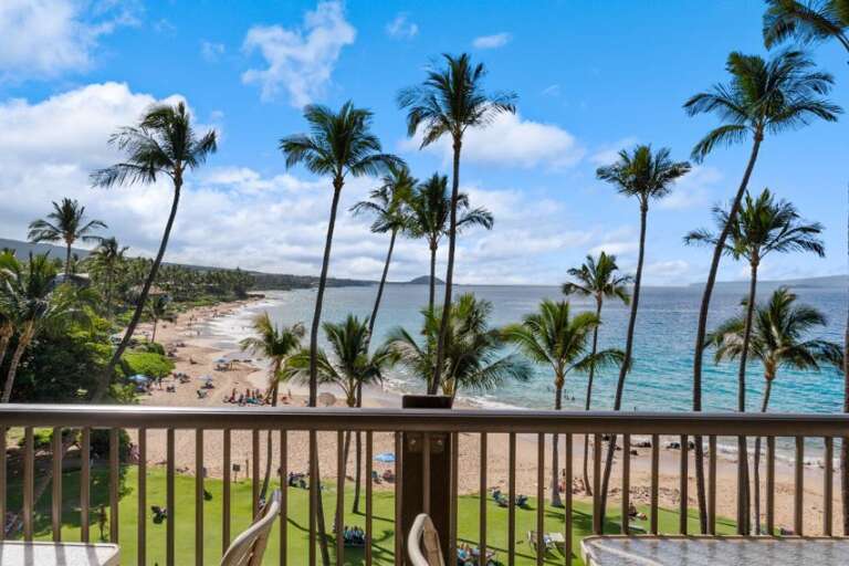 Balcony View Of Beach With Swaying Palm Trees And Serene Sea