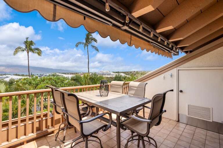 Balcony View With Table, Chairs, And Palm Panorama At A Vacation Rental