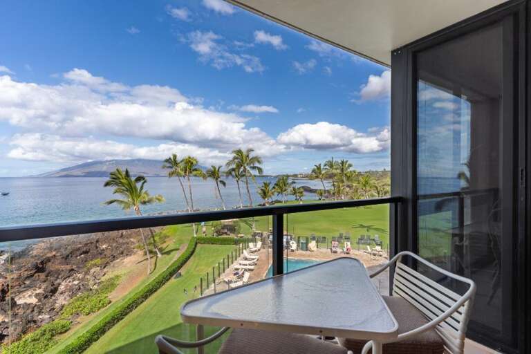 Balcony View Of Blue Sea, Sandy Shore, Swaying Palms
