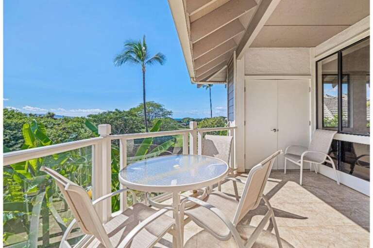 Balcony View Of Breezy Blue Sky And Lush Landscape With White Chairs And Table