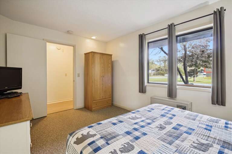This bedroom has a lot of natural lighting.