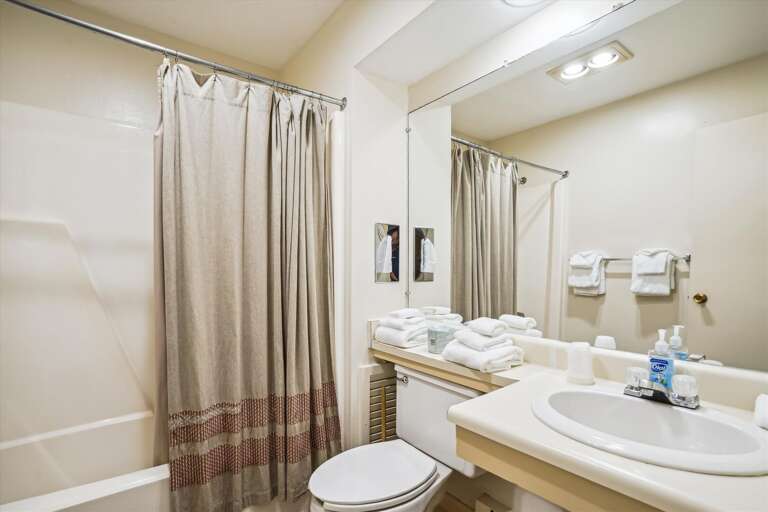 Full sized bathroom with a bathtub/shower combination.