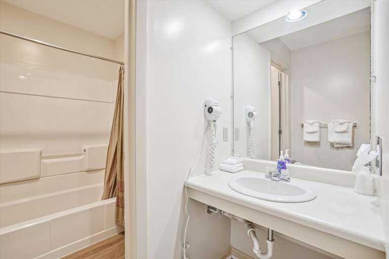 Full sized bathroom with a bathtub/shower combination.