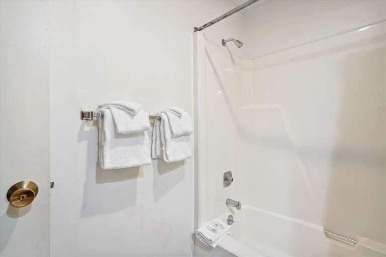 Full sized bathroom with a bathtub/shower combination.