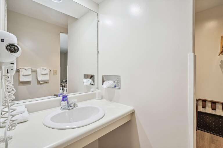 Full sized bathroom with a bathtub/shower combination.