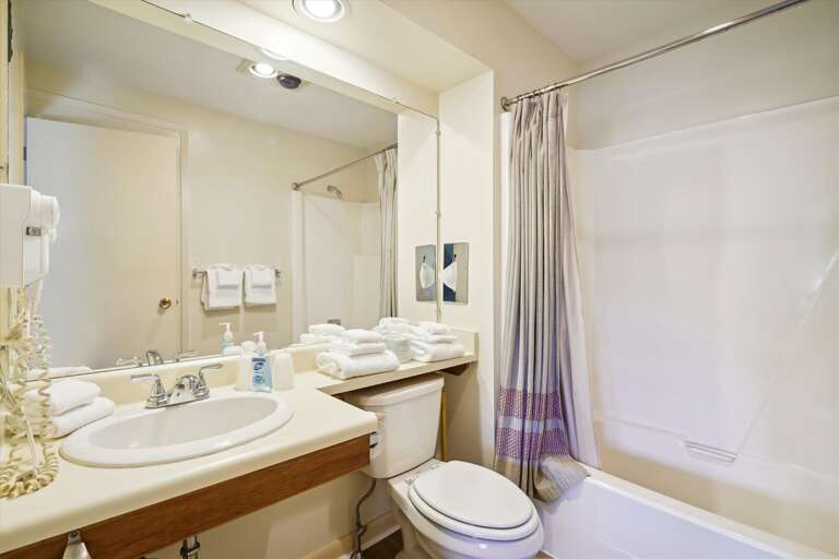 Full sized bathroom with a bathtub/shower combination.
