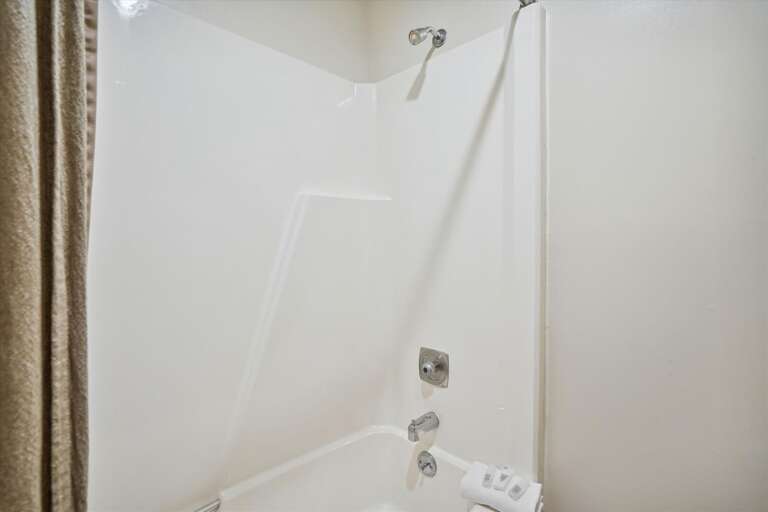 Full bathroom, with tub and shower combo