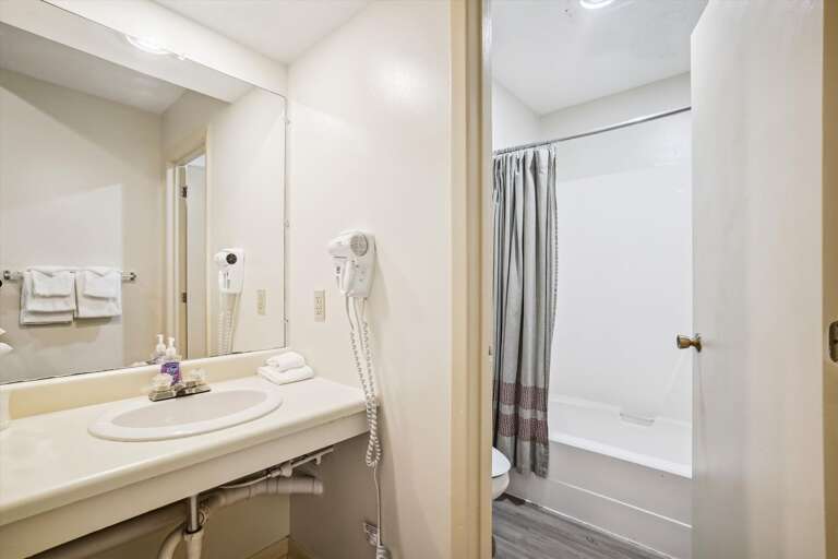 Full sized bathroom with a bathtub/shower combination.