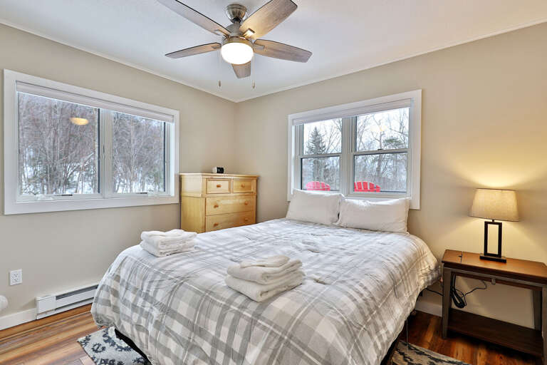 Bedroom with a queen bed and lots of wooded views. Bedroom with a queen bed and lots of wooded views.