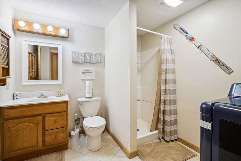 Bathroom with shower only, access to washer and dryer