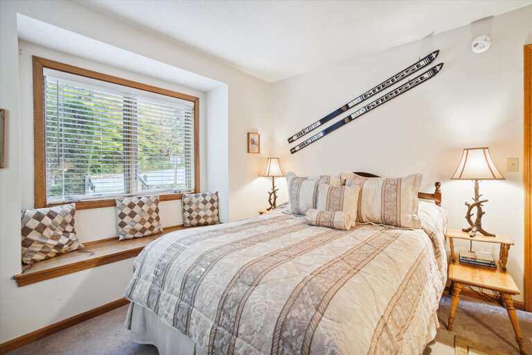 Queen bedroom with country decor with window seat.  Enjoy the surrounding atmosphere of the outside scenery.