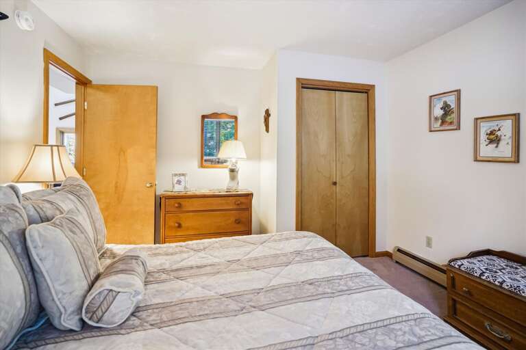 Queen bedroom with country decor with window seat.  Enjoy the surrounding atmosphere of the outside scenery.