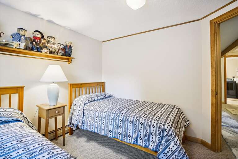 Two twin beds in this bright and comfortable bedroom.  Located in the lower level off of the family room