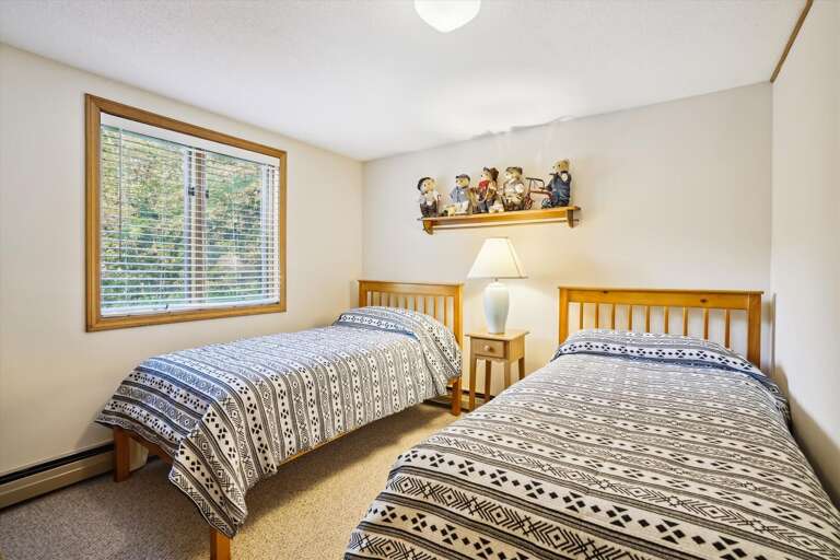 Two twin beds in this bright and comfortable bedroom.  Located in the lower level off of the family room