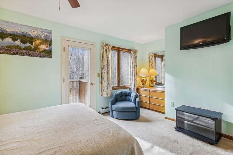 Well lit and comfortable bedroom.