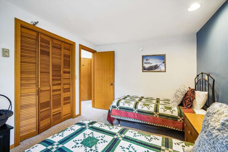 Bedroom With Two Beds And Wooden Closet Bedroom With Two Beds And Wooden Closet