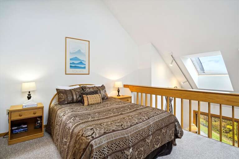 Queen bed in Loft with attached bathroom.