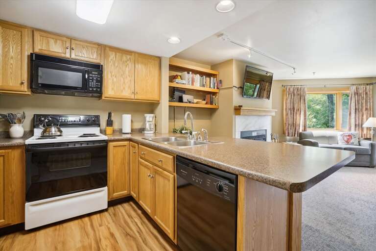 Full kitchen with microwave oven/stove, dishwasher, refrigerator, coffee maker, and other appliances.