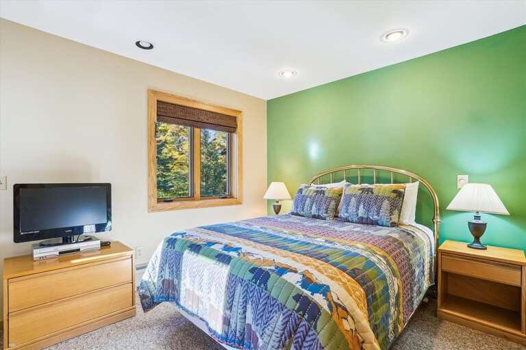 Quaint bedroom with a queen size bed.