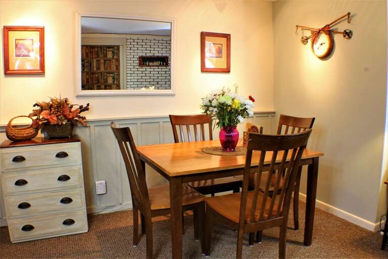 Dining area with a kitchen pass-through to living space.