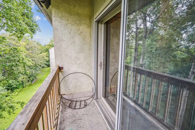 Access to private deck with wood view from living room
