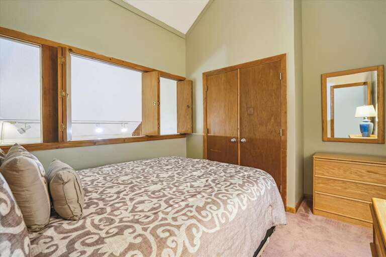 Queen bedroom located on the second floor of unit