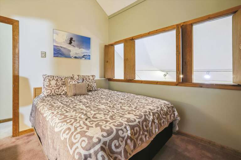 Queen bedroom located on the second floor of unit