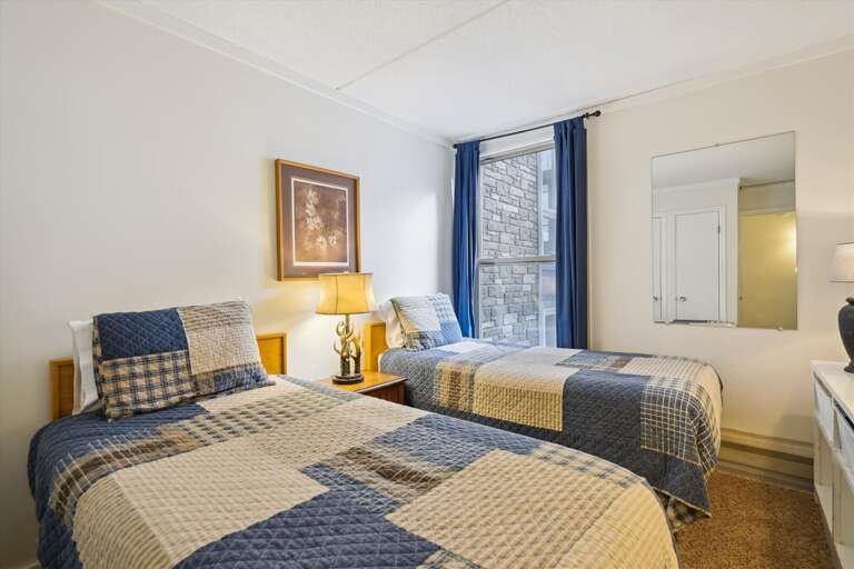 This bedroom has two twin beds.