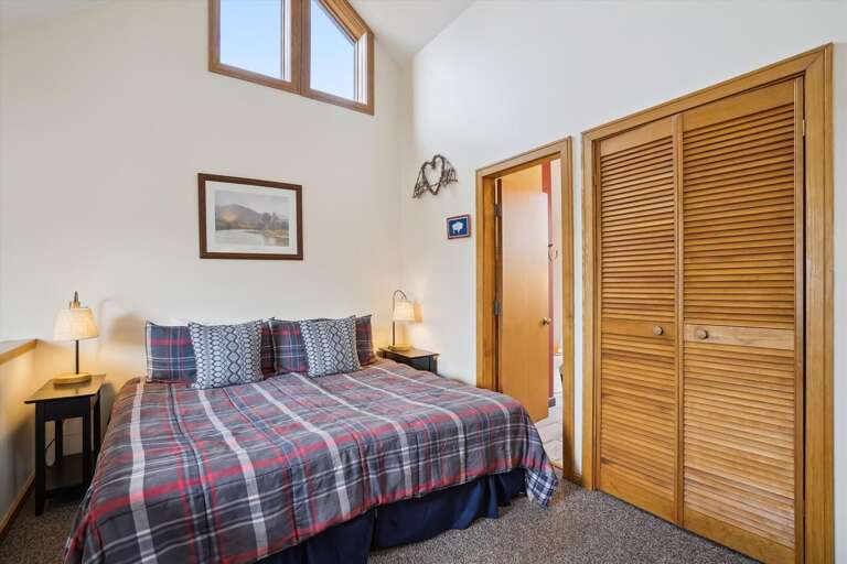 Bedroom in the loft with a king-sized bed and a full bathroom.