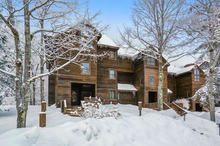 Snowy Scene Surrounding Serene Vacation Rental In A Wooded Winter Wonderland