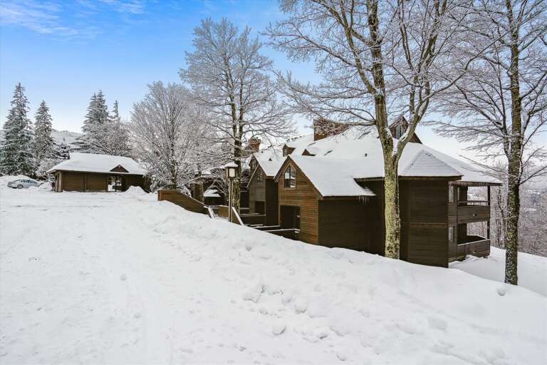 Snowy Scene With Secluded Cabins Nestled Amid Frosted Trees