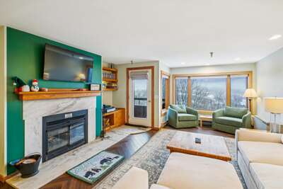 Bright Living Room with Fireplace & Mountain Views