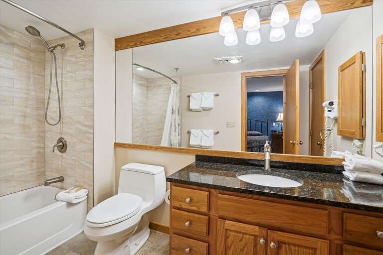 Upgraded full bathroom.  Large mirror to add depth to the room.