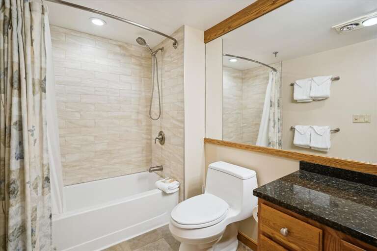 Upgraded full bathroom.  Large mirror to add depth to the room.
