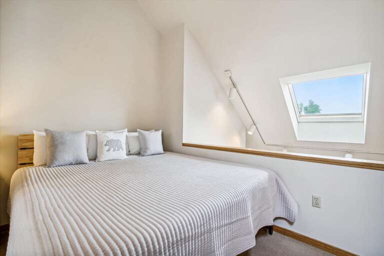 King sized bed in loft, attached bathroom with shower