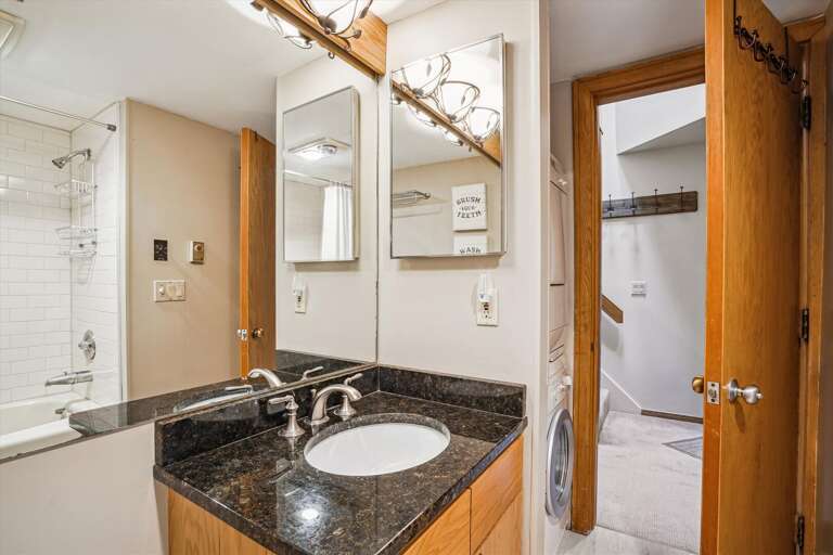 Main level full bathroom with access to washer and dryer