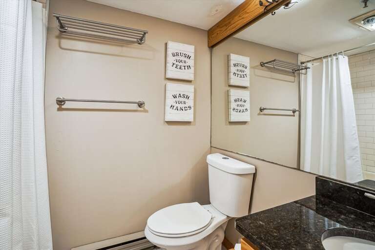 Main level full bathroom with washer and dryer