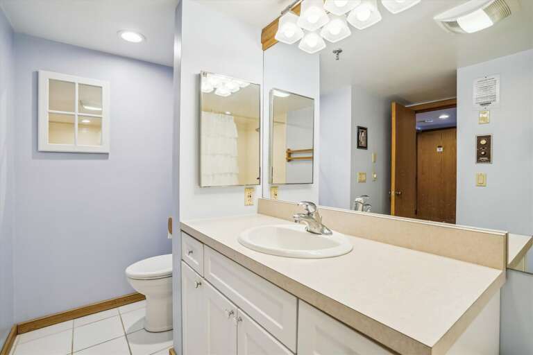 Brightly lit full bathroom. Brightly lit full bathroom.
