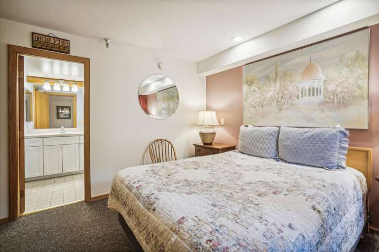 Queen bedroom with attached bathroom.  Features a small mini fridge and coffee pot. Queen bedroom with attached bathroom.  Features a small mini fridge and coffee pot.