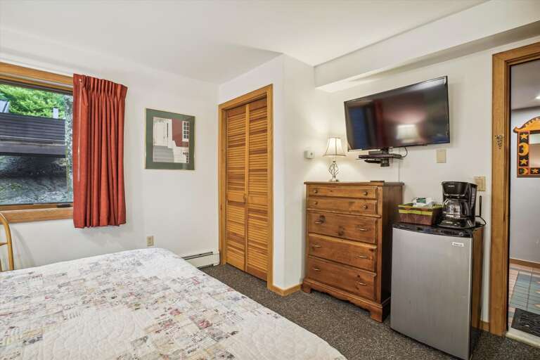Queen bedroom with attached bathroom.  Features a small mini fridge and coffee pot. Queen bedroom with attached bathroom.  Features a small mini fridge and coffee pot.