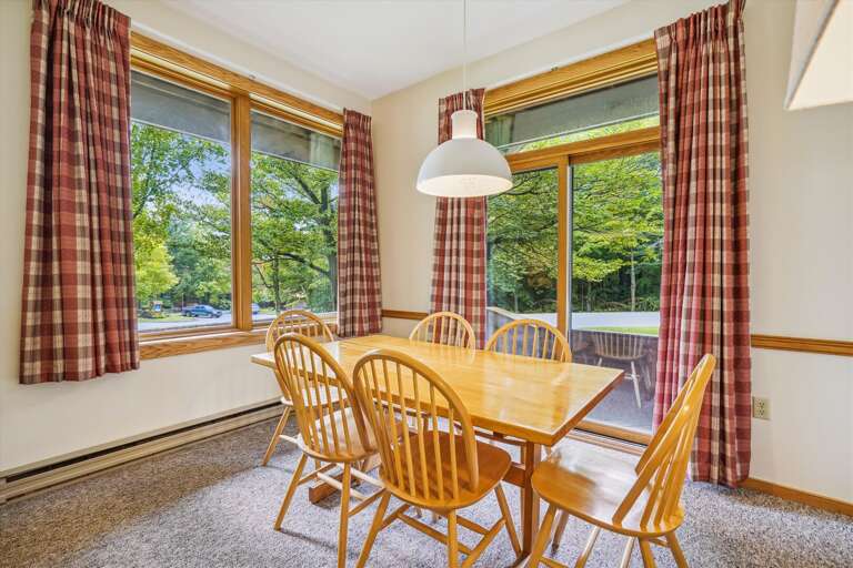 Dining room table seats 6 comfortably.  Natural lighting filters through with the large windows framing the natural scenery Highridge offers. Dining room table seats 6 comfortably.  Natural lighting filters through with the large windows framing the natural scenery Highridge offers.