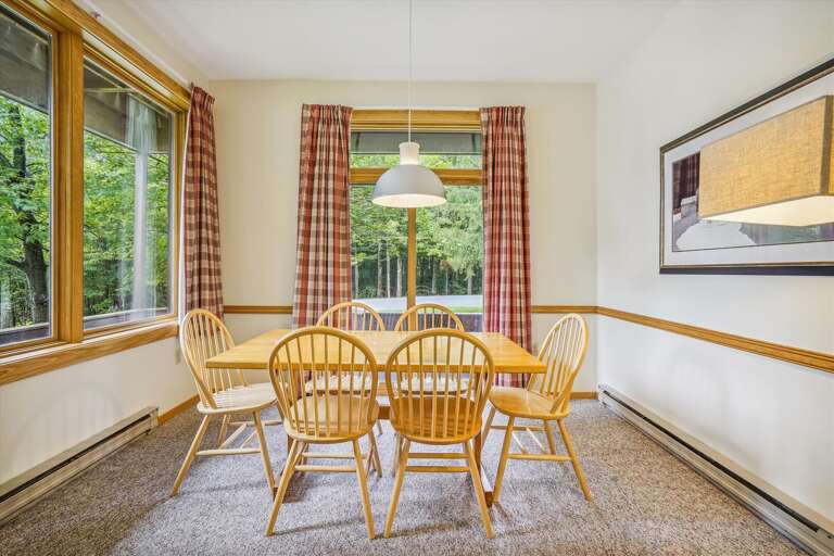 Dining room table seats 6 comfortably.  Natural lighting filters through with the large windows framing the natural scenery Highridge offers. Dining room table seats 6 comfortably.  Natural lighting filters through with the large windows framing the natural scenery Highridge offers.