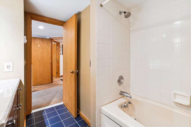 Full bathroom with tub/shower combo.