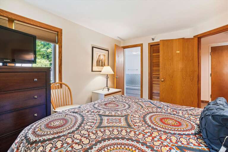 Queen bedroom with attached master bathroom with a whirlpool tub.