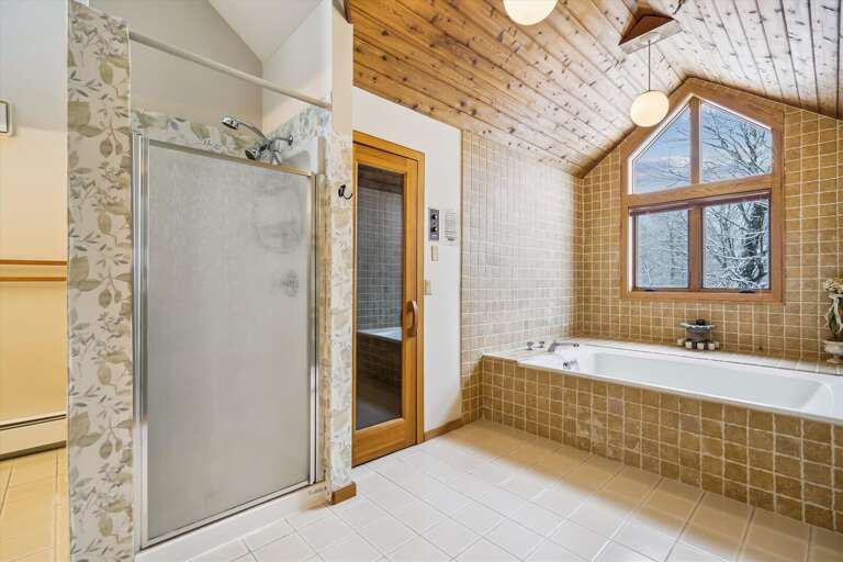 Beautiful full bathroom with sauna and whirlpool tub.