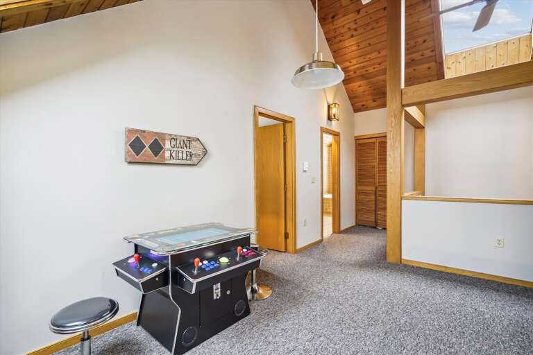 Sitting area in the loft, sports a futon for extra sleeping and with old timey arcade games!