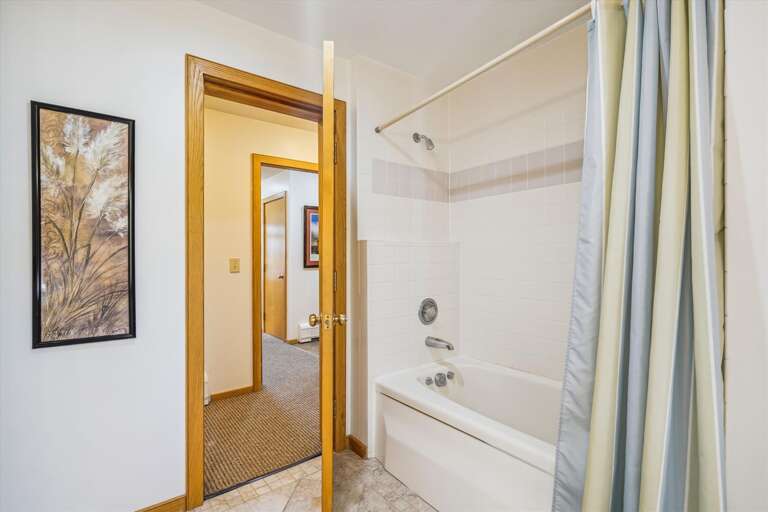 Full bathroom with tub/shower combo.
