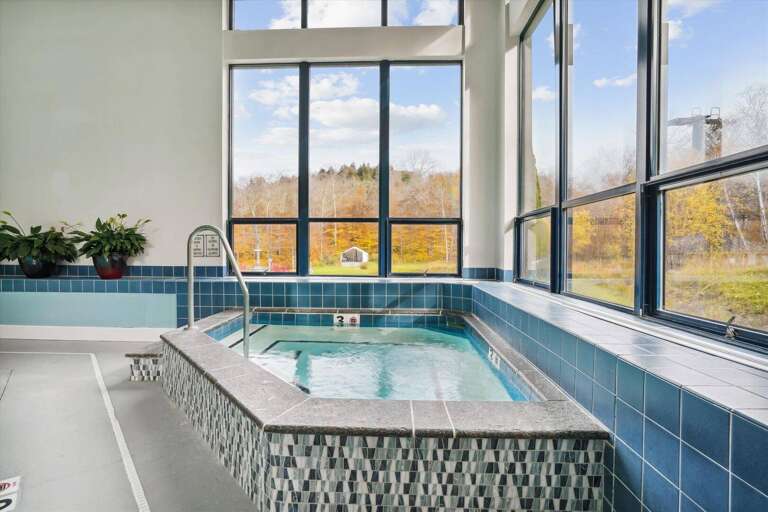 Indoor Pool With Panoramic Windows Overlooking Autumn Foliage Indoor Pool With Panoramic Windows Overlooking Autumn Foliage