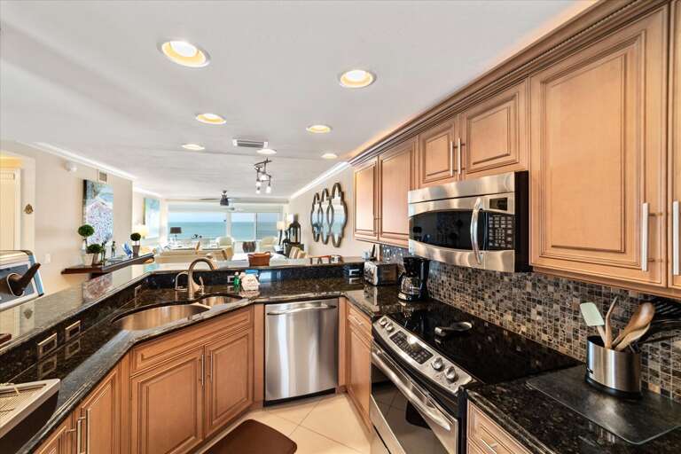 Spacious Kitchen With Sleek Stainless Steel Appliances And Wooden Cabinets Spacious Kitchen With Sleek Stainless Steel Appliances And Wooden Cabinets