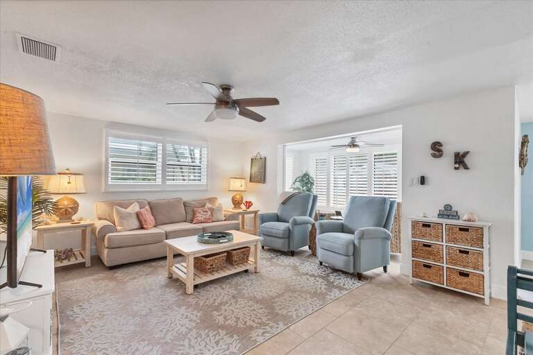 Bright, Breezy Vacation Rental Living Space With Plush Seating And Serene Setup